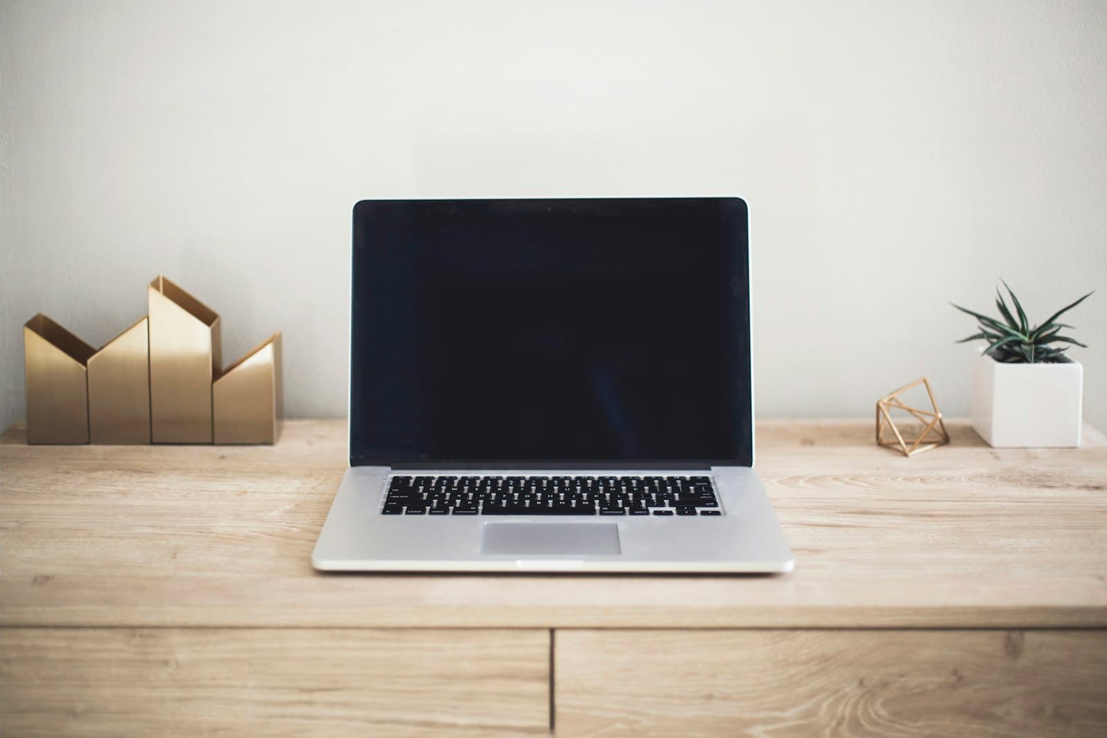 Laptop and notes used to draft website copy